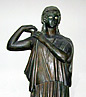 bronze woman fastening peplos